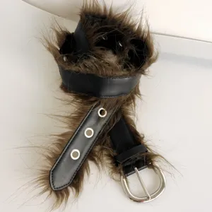 Brown faux fur leather belt with metal eyelets and silver buckle, stylish autumn accessory.
