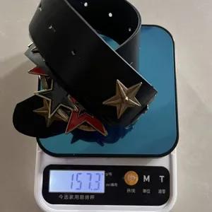 Punk style black leather belt with retro bronze and red metal star decorations for daily wear.