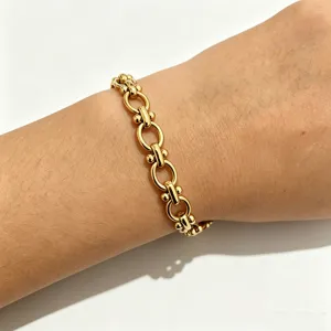 Gold metal link chain bracelet, minimalist stainless steel hand jewelry for daily wear.