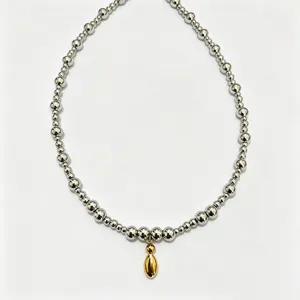 Stainless steel bead chain necklace with golden droplet pendant, stylish clavicle jewelry.
