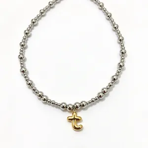 Stainless steel beaded chain necklace with cute gold puffy letter pendant fashion jewelry for women.
