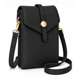 Black leather crossbody phone bag detail showing gold hardware clasp and fine textured surface