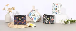 Detailed view of women's short folding PU leather wallets with cute cartoon prints and snap closures.