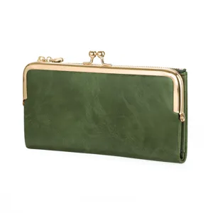 Detailed view of dark green retro long wallet with gold metal kiss-lock frame and zipper.