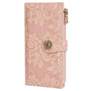Close-up of pink embossed floral women wallet with vintage sunflower snap button and dual zippers.