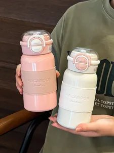 Detailed view of the portable dual-drink stainless steel insulated water bottle with strap.