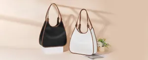 Stylish contrast color shoulder bag with large capacity and elegant brown handle design.