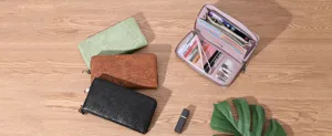 Detailed view of women's long floral embossed zip-around leather wallets with card slots.