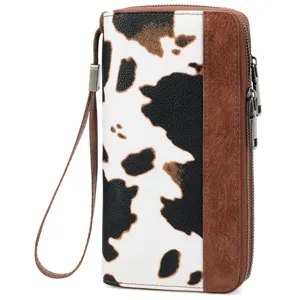 Close-up detail of women cow print dual zipper long wallet wristlet brown leather clutch.