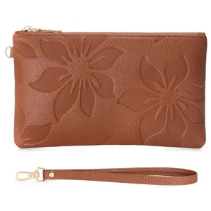 Women's long brown leather clutch bag featuring embossed floral pattern and wrist strap.