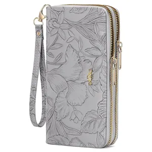 Detailed view of grey floral embossed long double zipper wallet with wrist strap clutch.