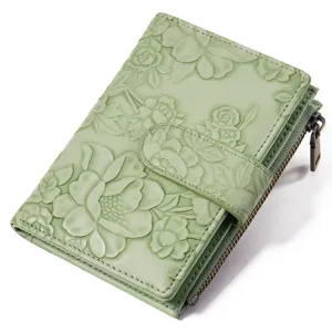 Close-up detail of the light green embossed floral PU leather short wallet zipper pouch.