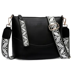 Black leather shoulder bag for women, stylish bucket bag with wide patterned strap.