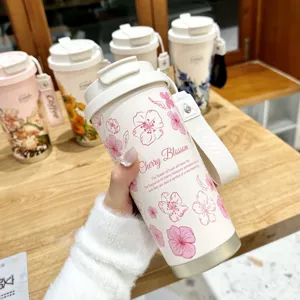 Portable stainless steel vacuum insulated coffee tumbler with strap and straw for daily use.