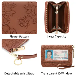 Detailed view of brown embossed floral card holder wallet with zipper and wrist strap.