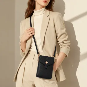 Black leather crossbody phone bag styled with a chic beige suit for a modern daily look.