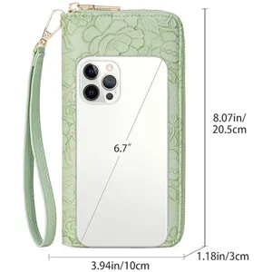 Green embossed long wallet for women with wrist strap and smartphone capacity display.
