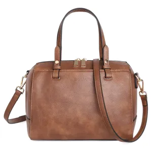 Detailed view of brown PU leather boston bag, featuring top handles and gold hardware.