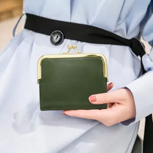 Dark green short wallet with metal kiss-lock clasp, retro leather coin purse detail view.
