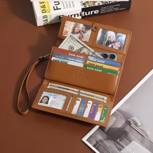 Vintage brown women's long trifold wallet with wrist strap, multiple card slots and cash pocket detail.