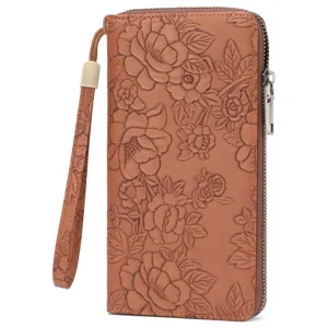 Detailed view of women long embossed floral wallet with zipper closure and wrist strap.