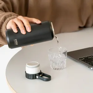 Modern black stainless steel insulated water bottle with handle for outdoor sports and daily use.
