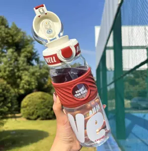 Detail view of large capacity sports water bottle with straw, red and white design for outdoor.