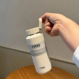 White vacuum insulated water bottle 500ml with portable handle for outdoor sports and daily use.