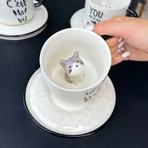 Creative cartoon relief ceramic mug with cute 3D cat inside, coffee cup and saucer set for home use.