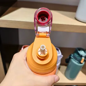 Bouteille d'eau isolée portable avec couvercle à paille, idéale pour le sport en plein air.