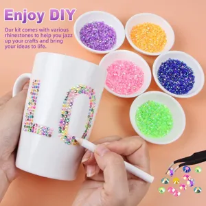 Close-up detail of DIY resin flatback rhinestones and tools for colorful craft decoration.