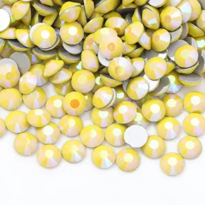 Detail view of sparkly yellow iridescent flatback rhinestones, perfect for nail art and DIY crafts.