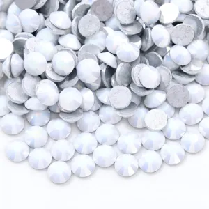 Close-up detail of white iridescent glass flatback rhinestones for nail art and DIY phone cases.