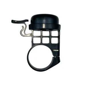 Detailed view of the black bicycle bell, showing metal and plastic structure and mounting ring.