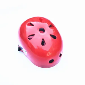 Red kids sports helmet detail view showing top plum blossom ventilation cooling holes.