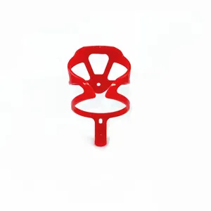 Close-up detail of lightweight red plastic bicycle water bottle cage for mountain bikes.
