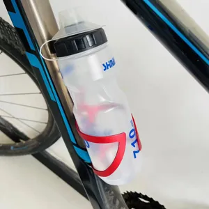 Bicycle water bottle cage with a 710ml translucent sport water bottle mounted on frame.