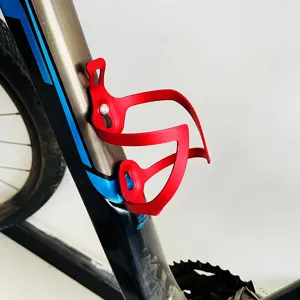 Red lightweight aluminum alloy bicycle water bottle cage for mountain and road bikes detail view.