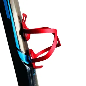 Red aluminum alloy bicycle water bottle cage, lightweight mountain and road bike cup holder.