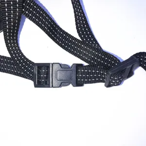Close-up detail of the black reflective adjustable strap and plastic buckle for safety gear.