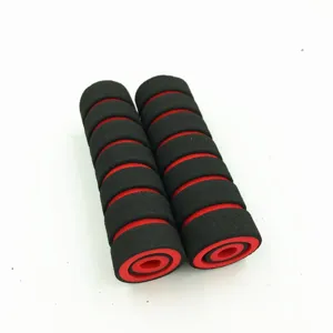 Detail shot of black and red sponge motorcycle handlebar grips, soft foam texture closeup.