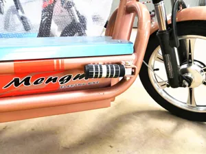Electric scooter modified aluminum rear footpeg detail shot showing robust metal and rubber design.