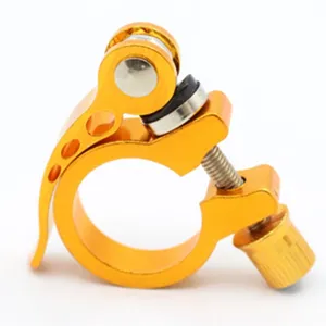 Detail shot of the golden aluminum alloy bicycle seatpost clamp with quick release lever.