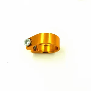 Orange bicycle seatpost clamp detail view, metal locking ring for mountain road bikes.
