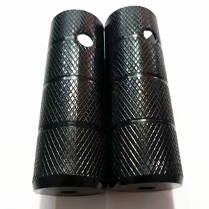 Close-up view of heavy-duty steel bicycle stunt pegs featuring durable knurled texture design.