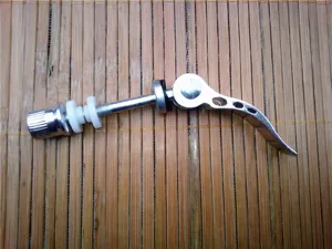 Detailed view of bicycle quick release seatpost clamp skewer, metal lever and screw.