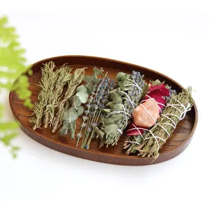 Natural dried flower and herb bundles with wooden tray for aromatherapy DIY craft decor.