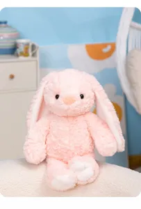Soft pink plush bunny toy with long floppy ears, cute fluffy texture, perfect comforting companion.