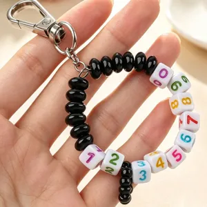 Handmade beaded keychain with number cubes and metal clasp for bag or golf score tracking.