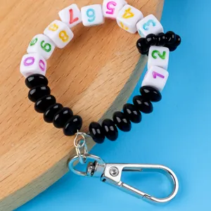 Close-up detail of colorful number bead keychain wristlet with metal clasp for bags and keys.